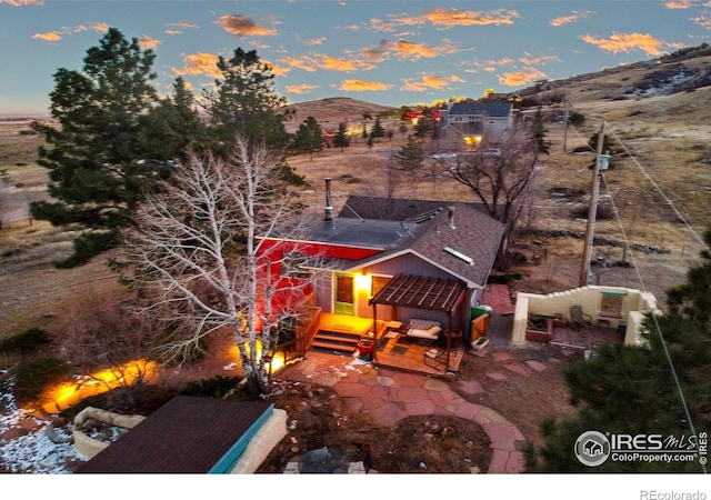 aerial view at dusk featuring a mountain view