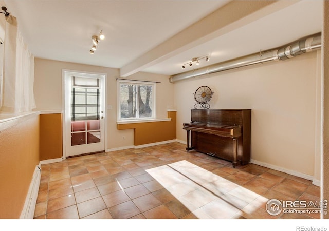 doorway to outside featuring beamed ceiling, light tile patterned flooring, and a baseboard radiator