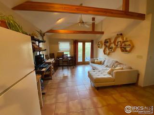 living room with lofted ceiling with beams, french doors, and ceiling fan