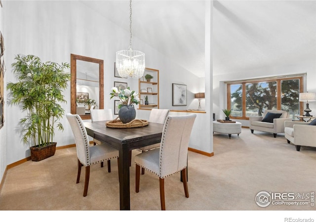 dining area featuring high vaulted ceiling, light carpet, and a chandelier