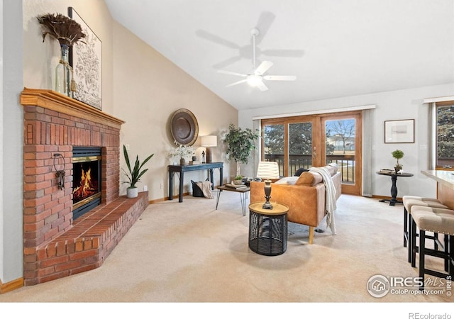 living room with a brick fireplace, lofted ceiling, light colored carpet, and ceiling fan