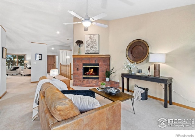 living room featuring light carpet, ceiling fan, and a fireplace