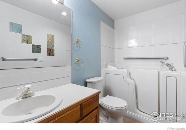 bathroom with toilet, a bathing tub, decorative backsplash, and vanity