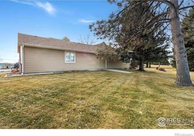 view of side of home with a lawn