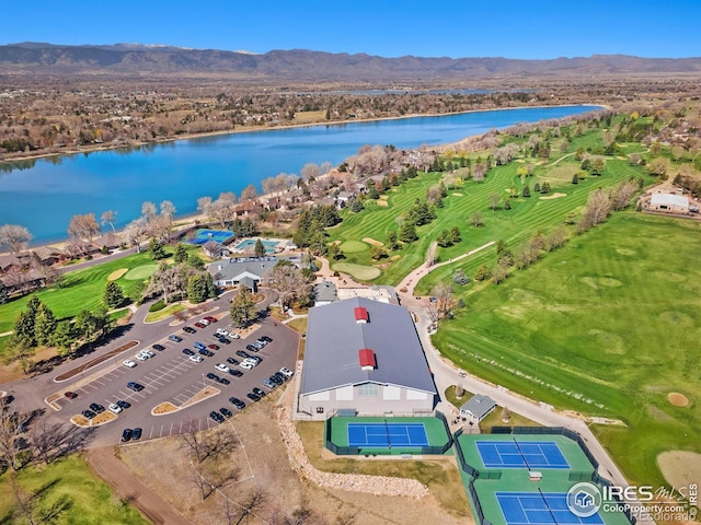 birds eye view of property with a water and mountain view