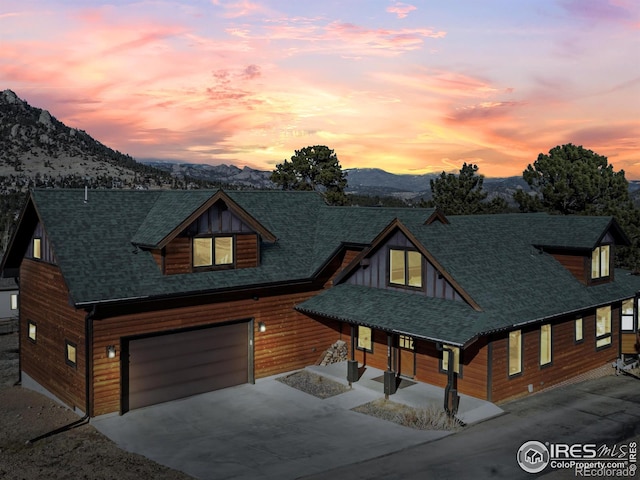 view of front of property with a mountain view and a garage