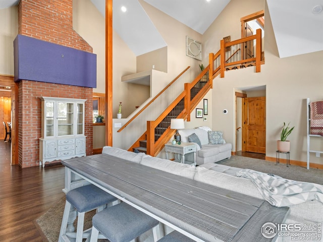 dining space with dark hardwood / wood-style flooring and a towering ceiling