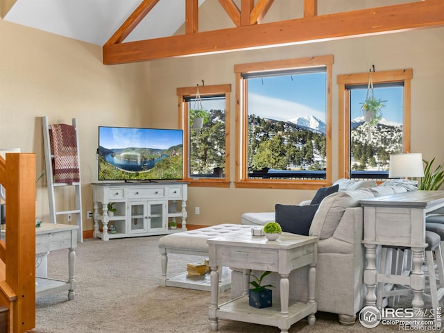 carpeted living room with high vaulted ceiling and beamed ceiling