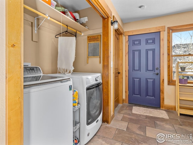 clothes washing area with washer and clothes dryer