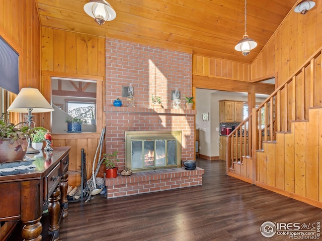 living room featuring lofted ceiling, wood ceiling, dark wood-type flooring, wooden walls, and a fireplace