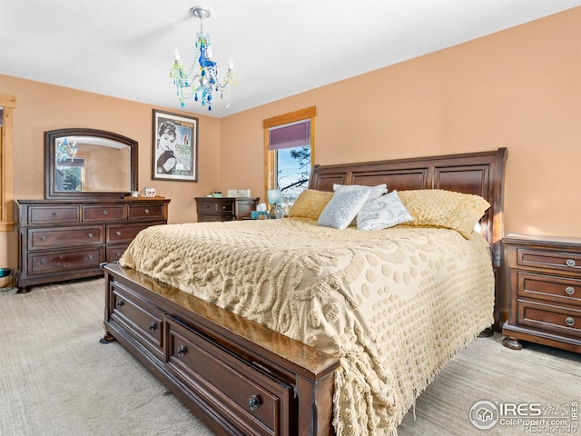 carpeted bedroom with a notable chandelier