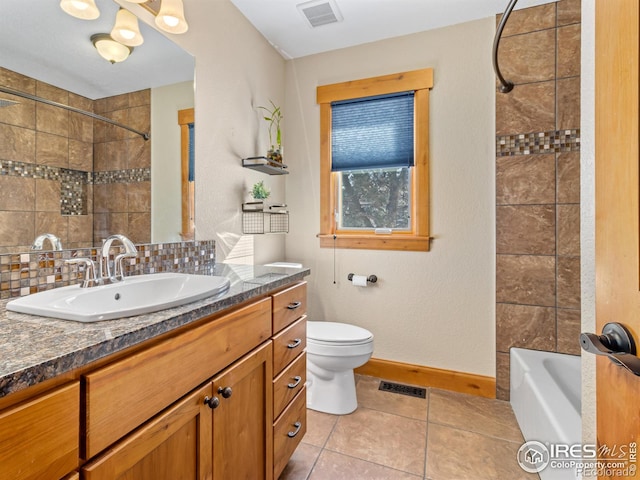 full bathroom with toilet, tile patterned floors, vanity, backsplash, and tiled shower / bath