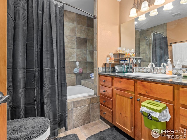 bathroom with vanity, shower / bathtub combination with curtain, and tile patterned flooring