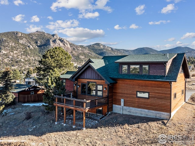 back of house with a deck with mountain view