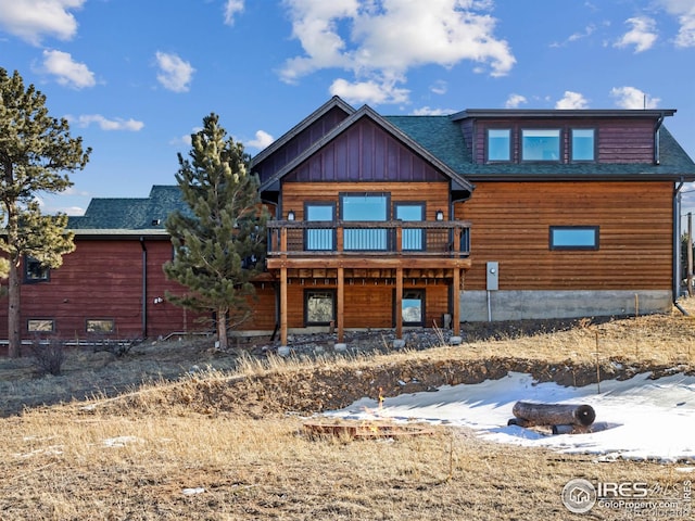 log-style house with a wooden deck