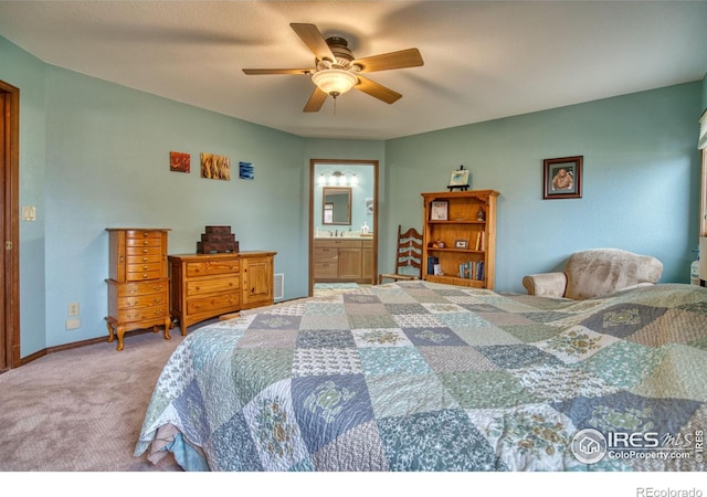 carpeted bedroom with connected bathroom and ceiling fan