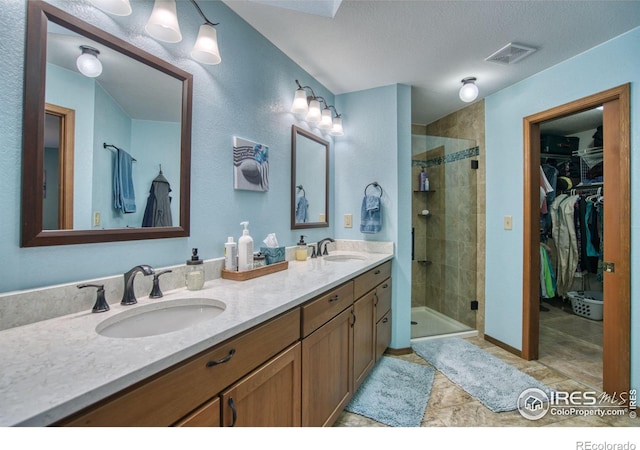 bathroom featuring vanity and a shower with door