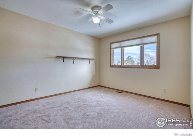 spare room with ceiling fan and carpet flooring