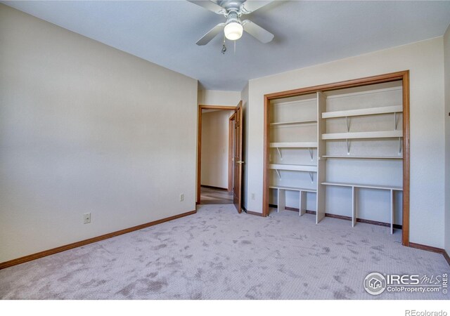 unfurnished bedroom with light colored carpet, ceiling fan, and a closet