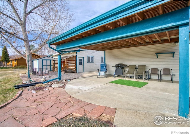 view of patio / terrace with a shed and grilling area