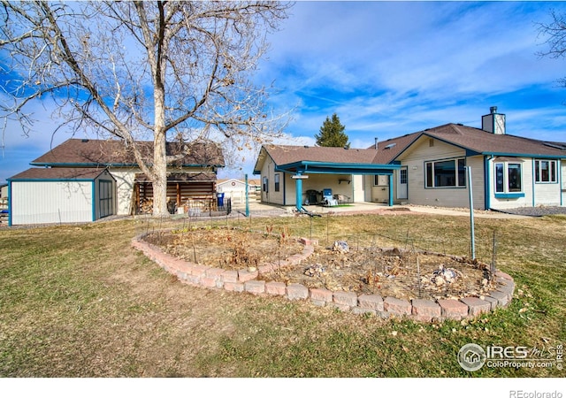 back of house featuring a storage shed, a patio, and a lawn