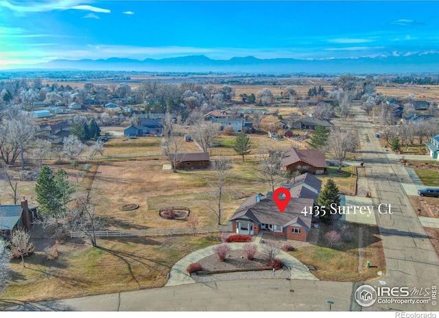 birds eye view of property with a mountain view