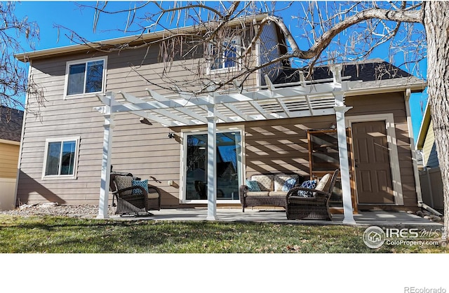 back of house featuring a lawn, a pergola, and a patio