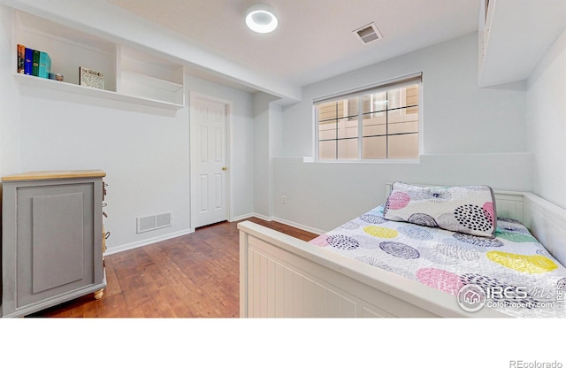 bedroom featuring dark hardwood / wood-style flooring