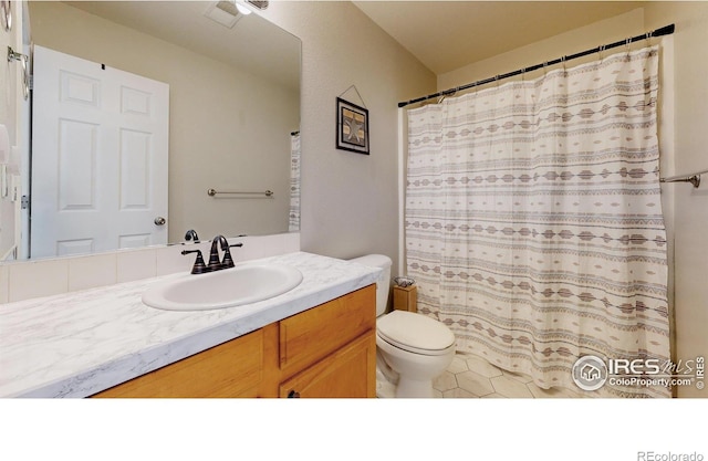 bathroom featuring toilet, vanity, and walk in shower