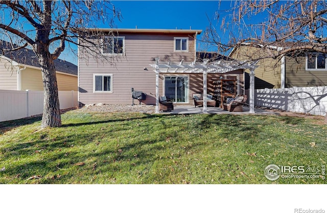 back of property featuring a yard, a patio, and a pergola