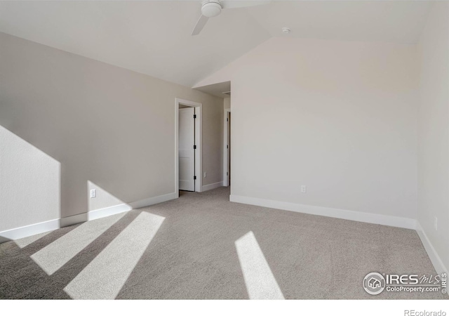 spare room with lofted ceiling, light colored carpet, and ceiling fan