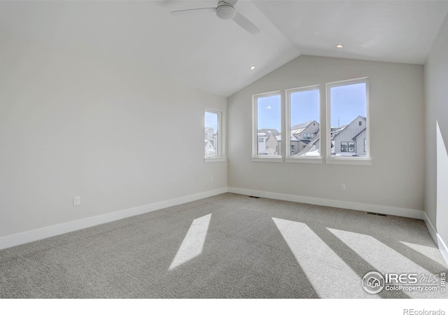 interior space with ceiling fan, vaulted ceiling, and light carpet