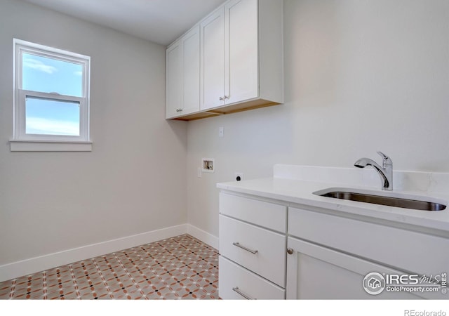 laundry area with electric dryer hookup, sink, hookup for a washing machine, and cabinets