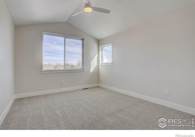 unfurnished room featuring lofted ceiling, light carpet, and ceiling fan