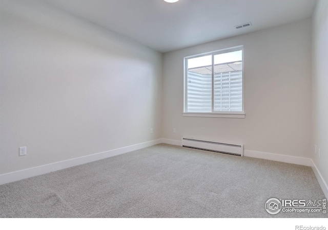 carpeted empty room featuring a baseboard radiator