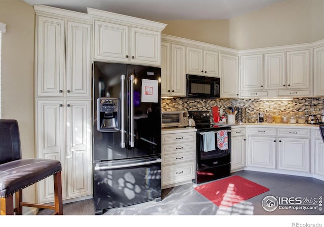 kitchen with black appliances, vaulted ceiling, and tasteful backsplash