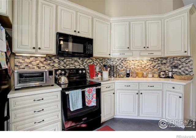 kitchen featuring black appliances and tasteful backsplash