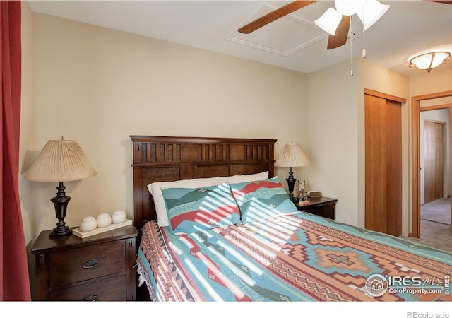 bedroom featuring ceiling fan and a closet