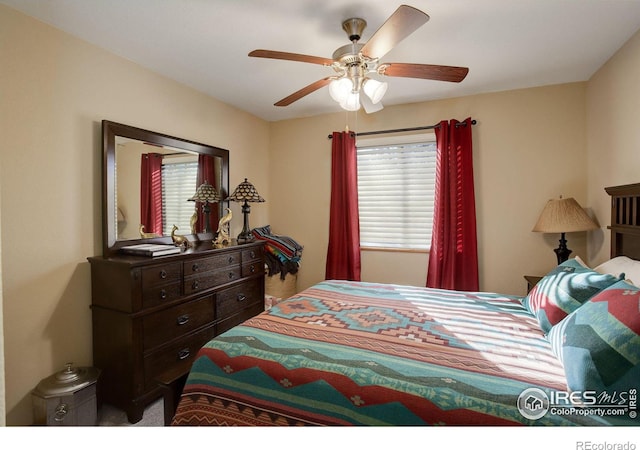 bedroom featuring ceiling fan and multiple windows