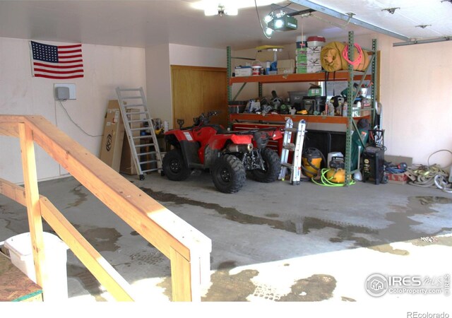 garage featuring a garage door opener and a workshop area