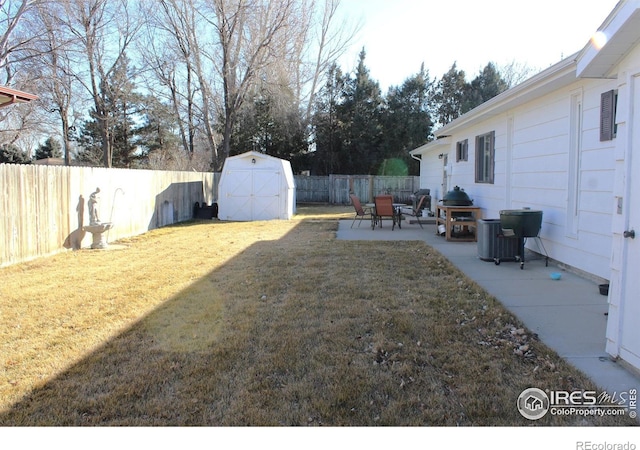 view of yard with a patio area, central air condition unit, and a shed