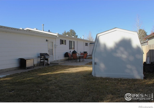 rear view of house featuring a patio and a lawn