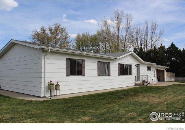 ranch-style home featuring an attached garage and a front yard