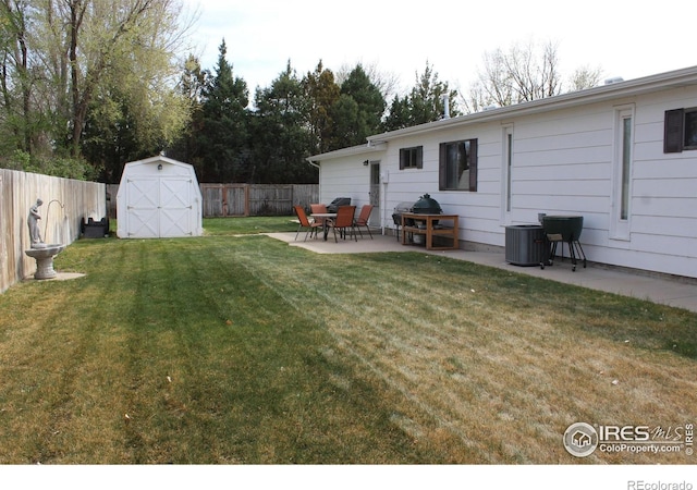 view of yard featuring a shed, a fenced backyard, cooling unit, a patio area, and an outdoor structure