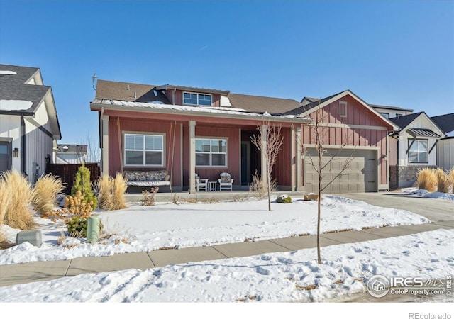 view of front of home featuring a porch and a garage