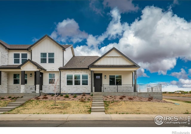 648 Greenspire Dr Unit 4, Windsor, CO 80550 - view of front of property featuring stairs, board and batten siding, and a porch