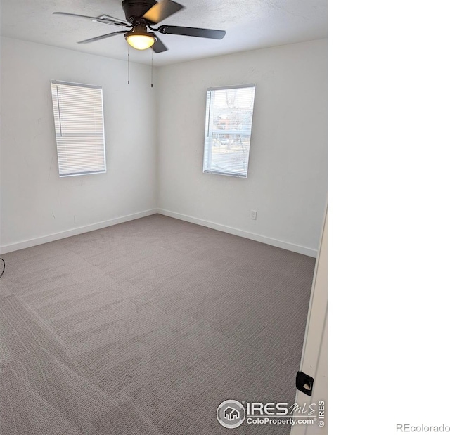 carpeted empty room featuring ceiling fan