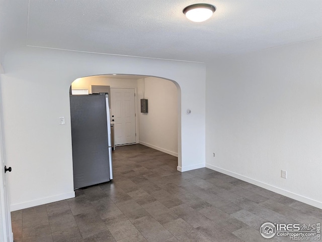 empty room featuring a textured ceiling