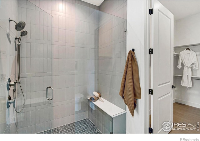 bathroom with an enclosed shower and toilet