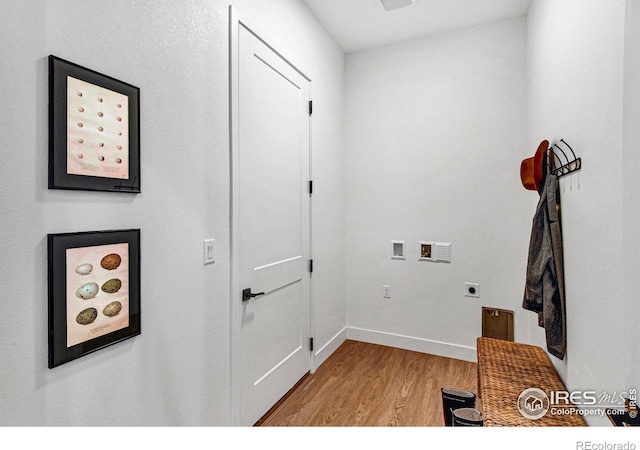 laundry room featuring light hardwood / wood-style floors, electric dryer hookup, and hookup for a washing machine